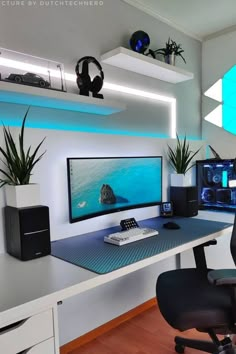 a desk with a computer monitor, keyboard and headphones on it in front of some plants