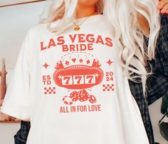 a woman wearing a white las vegas t - shirt with the words, 777 all in for love on it