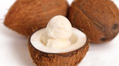 two coconuts with ice cream in them on a white surface