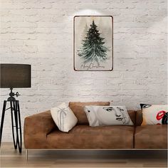 a living room with a couch, lamp and christmas tree hanging on the brick wall