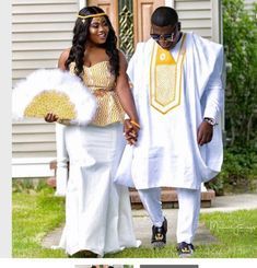 a man and woman dressed in traditional african clothing