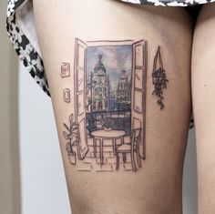 a woman's thigh with a reflection of a building in the mirror on it