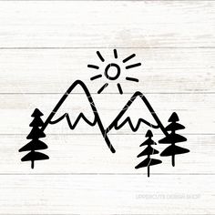 a mountain with pine trees and the sun above it on a white wooden background that is painted in black