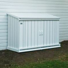 a white storage box sitting in front of a building