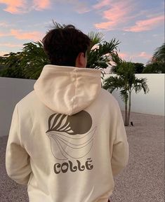 the back of a person wearing a white hoodie that says colle on it