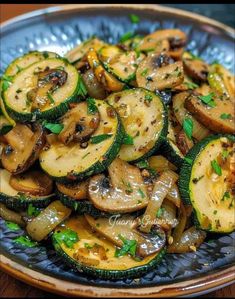 a blue plate topped with sliced up zucchini and mushrooms on top of a wooden table