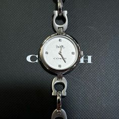 Enjoy V Beautifil Coach Watch With 26mm Silver Face With Silver Hands & Crystals On Its Hourmarkers & Coach Signature "C" Silver Chain Bracelet. It's Original Retail Price Is $275 & Overheads. Enjoy This Gorgeous & Unique Timepiece At Great Discounted Price. Coach Watch, Silver Chain Bracelet, Coach Accessories, Silver Watch, Accessories Watches, Chain Bracelet, Time Piece, Silver Chain, Women Accessories