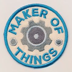 a blue and white patch with the words maker of things on it's side