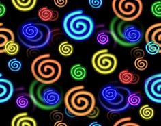 many colorful spirals are glowing in the dark