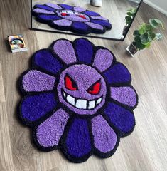 a purple and black rug with an evil flower on the floor next to a mirror