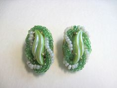 "Vintage Elsa Schiaparelli green art glass bead earrings circa 1930s.  Schiaparelli jewelry is highly prized and collectible.  These earrings are signed and are in lovely condition.  There is minor usage wear to the reverse side of the earrings but otherwise are in beautiful condition.  Measure approximately 1\" long.  Please review the photographs to see the condition issues up close.   The fixed shipping fee applies to US customers only. This item will ship via USPS insured mail. International customers should contact us, prior to purchase, to check on shipping availability and associated fee(s). Our goal is to have your experience with us be a positive one. Therefore it is important to us that you get a clear understanding of what you are considering before you purchase. All of our piec Schiaparelli Jewelry, Glass Bead Earrings, Elsa Schiaparelli, Jewelry Ads, French Fashion Designers, Green Art, May 11, Bead Earrings, French Fashion