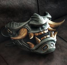 Oni cyberpunk half mask. This is an original Oni mask created by the Maskitto team. The height of the mask (with fangs) is 155 mm, the width is 205 mm. depth 125 mm. The mask fits perfectly on an adult's head and has holes for a strap.The mask is hand painted. Fangs Mask, Cyberpunk Oni, Oni Maske, Oni Samurai, Ronin Samurai, Samurai Mask, Old Ties, Wolf Mask, The Company You Keep