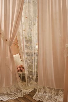 the curtains are open and ready to be hung in the room with lace on them