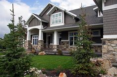 a house with stone walls and green grass