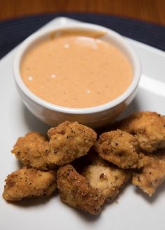 fried food on a plate with dipping sauce