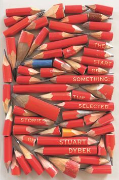 many red pencils with writing on them are arranged in the shape of a square