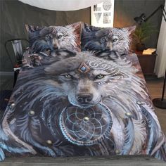 a bed with two wolfs on it and one has a dream catcher in its mouth