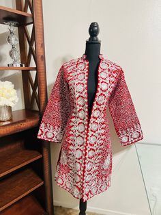 Item#A30 Country of Origin: Afghanistan  Design: Custom Material: velvet and embroidery  Our amazing embroidered Afghan women coat/jacket is an absolute stunning piece . The color combination "Red and silver" of this piece makes it distinct from any other coat.  This is an extraordinary piece of outerwear for women. It has amazing embroidery work in front of the coat which makes is best for festivals and cultural events. Size Info: length: 36.5 inches shoulder: 15 inches  Waist: 42 inches  Chest Long Outerwear With Chikankari Embroidery, Embroidered Long Coat For Festive Occasions, Embroidered Cotton Outerwear With Stand Collar, Festive Embroidered Outerwear With Stand Collar, Fitted Cotton Outerwear With Resham Embroidery, Red Embroidered Long Outerwear, Red Winter Outerwear With Intricate Embroidery, Red Intricately Embroidered Winter Outerwear, Red Long Embroidered Outerwear