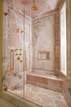 a walk in shower sitting next to a window with a light fixture on the ceiling