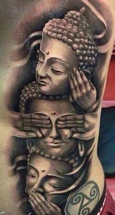 a man's back with a buddha tattoo on his stomach and hands holding the head of another person