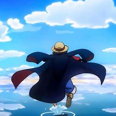 a man flying through the air while wearing a blue coat and hat with his arms spread out