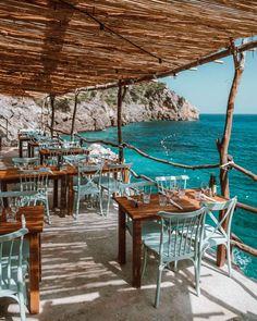 an instagram page with tables and chairs near the ocean