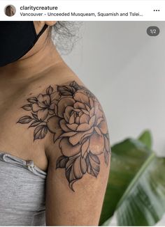 a woman with a flower tattoo on her shoulder