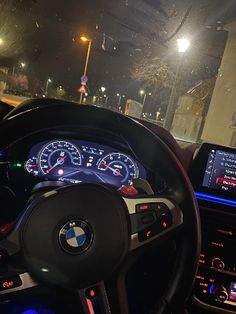 the interior of a bmw car at night