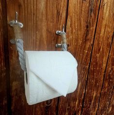 a roll of toilet paper hanging on a wooden wall