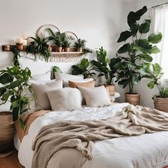 a bed with white linens and plants on the headboard