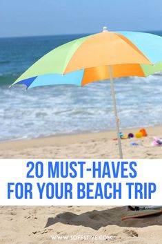 an umbrella on the beach with text overlay reading 20 must - haves for your beach trip