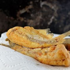 two fried food items sitting on top of a napkin