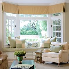 a living room with two couches and a coffee table in front of a window