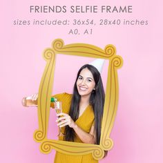 a woman in a yellow dress is holding a bottle and posing for a photo with her friends selfie frame