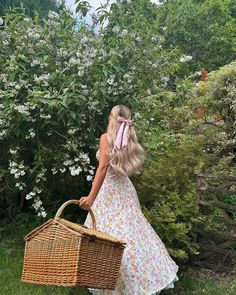 a woman with long blonde hair carrying a wicker basket and wearing a pink bow