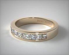 a rose gold wedding band with princess cut diamonds in the center and channeled sides