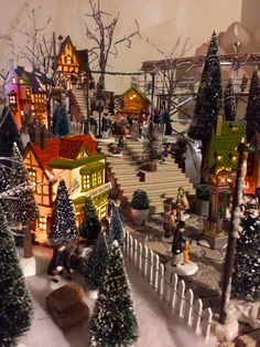 a christmas village is shown with trees and lights