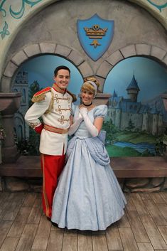 a man and woman dressed up as disney characters