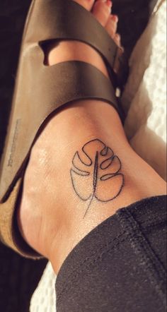 Small plant tattoo on ankle Jade Tattoo Plant, Hidden Women Tattoos, Monstera Ankle Tattoo, Plant Tattoo Ideas Female, Tropical Ankle Tattoo, Linework Arm Tattoo, Friendship Plant Tattoo, Plant Matching Tattoos, Small Above The Knee Tattoos Women