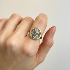 24KT yellow gold infused + sterling Silver Roman figure coin ring in a bezel setting with diamonds. 24k gold infused bail and bezel setting with silver coin (2) natural diamonds Roman figure coin Coin measures: 16mm Size 7 ONLY Weight: 5.1 grams .02 CTW natural diamond Rustic finish to silver Coin Ring, 24kt Gold, Silver Coin, Silver Coins, Bezel Setting, Natural Diamonds, Diamond Ring, Coin, Diamonds