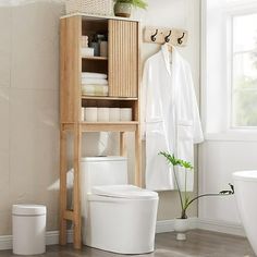 This over the toilet storage cabinet features a unique corrugated recessed panel with blister molding technology that adds texture and a sense of space, creating an extraordinary piece for your space. With white faux marble countertop with melamine veneer, delicate texture. With smooth curved edges and wide metal handles, it has both classic and modern charm.Maximize the size of your organization with our multifunctional cabinets. With adjustable shelves, sliding doors and a semi-open bottom com Over The Toilet Storage Cabinet, Toilet Storage Cabinet, Faux Marble Countertop, Over Toilet Storage, Over The Toilet Storage, Over The Toilet Cabinet, Freestanding Bathroom Cabinet, Over The Toilet, Furniture Storage Cabinets