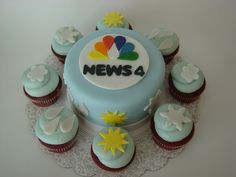 cupcakes and cakes are arranged around the news logo on top of a cake