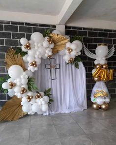 balloons and decorations are set up in front of a brick wall for a church event