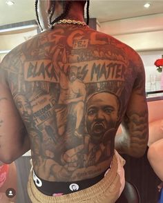 the back of a man with tattoos on his body