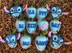 blue frosted strawberries decorated like cartoon characters with pink flowers and leaves in the shape of hearts