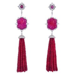 These stunning exceptional tassel earrings is handmade in 18-karat gold. It is set with 128.2 carats ruby and 3.09 carats of glittering diamonds. FOLLOW MEGHNA JEWELS storefront to view the latest collection & exclusive pieces. Meghna Jewels is proudly rated as a Top Seller on 1stDibs with 5 star customer reviews. All items manufactured by us are handmade and can be customized or redesigned. Composition Size-110X22 MM Total Weight-42.98 Gold Weight(Gms)-16.582 Diamond Wt(Cts)-3.09 Carved Ruby Wt(Cts)-128.2 Luxury Ruby Earrings For Evening, Luxury Latkans Earrings For Formal Occasions, Stone Accessories, Beaded Tassel Earrings, Ruby Beads, Long Tassel Earrings, Diamond Glitter, White Gold Jewelry, Lovely Jewellery