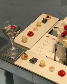 an assortment of desserts are on display in a glass case at the museum's exhibit