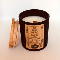 a black candle sitting next to a wooden container