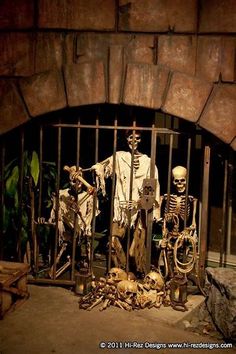 skeleton statues in front of an iron gate