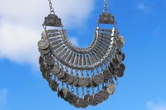 This bold Moroccan statement necklace is an eye-catching piece featuring intricately designed silver-tone coins that reflect a tribal essence. The handmade craftsmanship and ethnic detailing make it a perfect boho-chic accessory for festivals, cultural events, or adding flair to everyday outfits. Whether paired with a simple top or a flowing dress, this necklace elevates any look with its unique fusion of Moroccan tradition and modern bohemian style. 🤍✨ - Features detailed silver-tone coins and Modern Bohemian Style, Boho Chic Accessories, Festival Mode, Simple Top, Cultural Events, Modern Bohemian, Boho Stil, Coin Necklace, Necklace Handmade